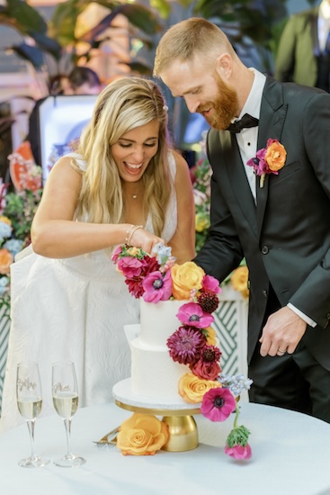 Bride and groom cutting their wedding cake