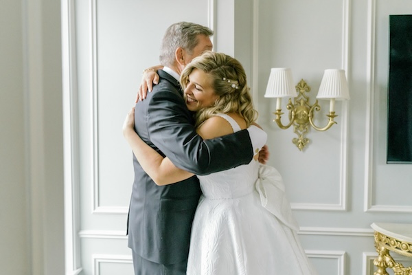 Bride embracing her father before her wedding ceremony