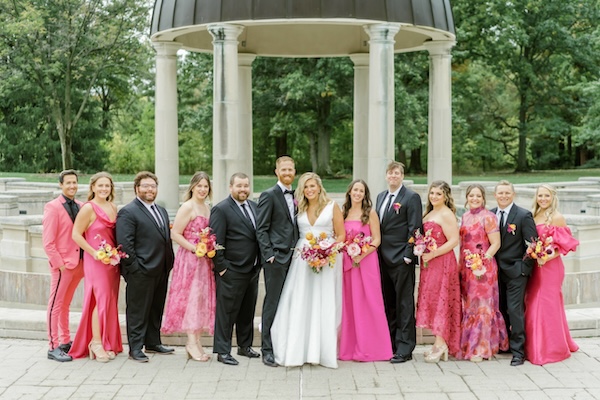 Wedding party in bright pink gowns at Coxhall Gardens