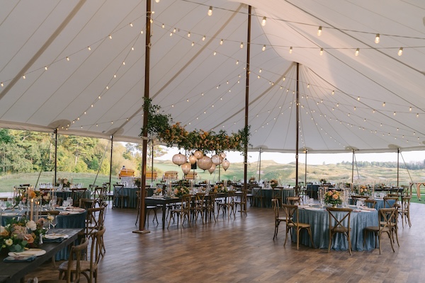 Beautiful wedding reception decor under a pole tent at Whispering Straits.