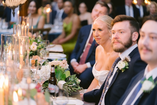 Bride and groom listening to wedding toasts at their Whistling Straits wedding reception.