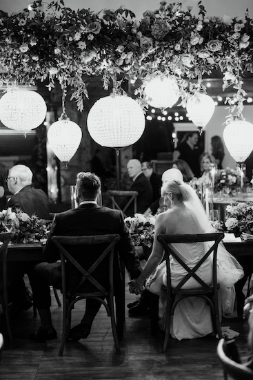 Bride and groom listening to wedding toasts at their Whistling Straits wedding reception.