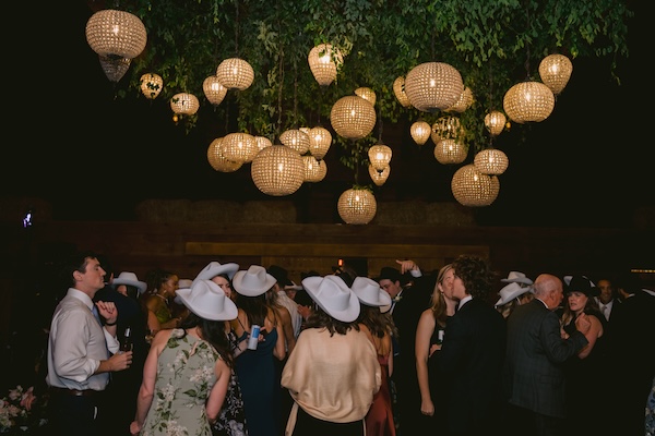 Guests received cowbaoy hats during a Whistling Straits wedding reception, a nod to the grooms home of Montana.