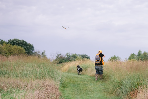 Groom phesant hunting beofre his Wisconsin destination wedding