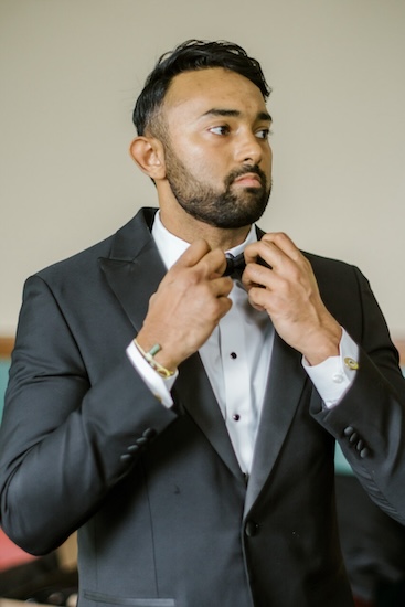 Indianapolis groom fixing his bow tie beofre his wedding ceremony.