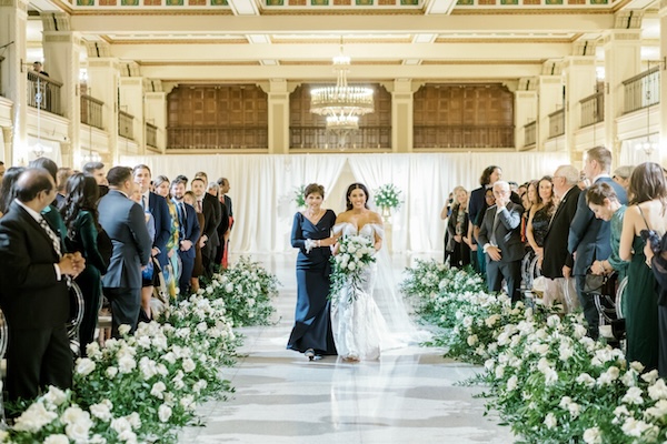 Mother of the bride escorting her daughter down the aisle.