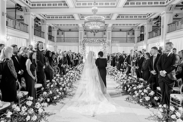 Mother of the bride escorting her daughter down the aisle.