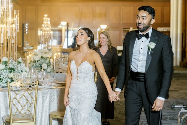 The bride and groom take a sneak peek at their luxurious Indianapolis Central Library wedding reception with designer Monica Richard of Mon Amie Events.