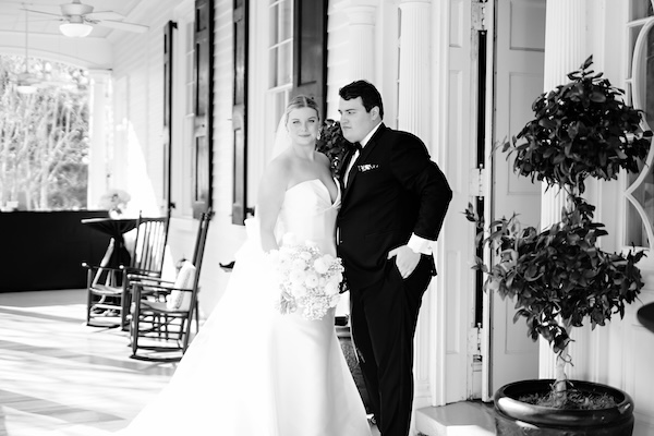 Bride and groom on the front porch of the Governor Thomas Bennett House in Charleston South Carolina