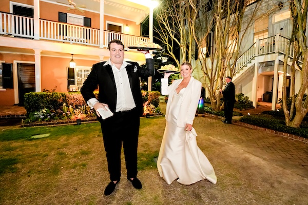 Bride and groom serving burgers for late night snacks at their Charleston destination wedding