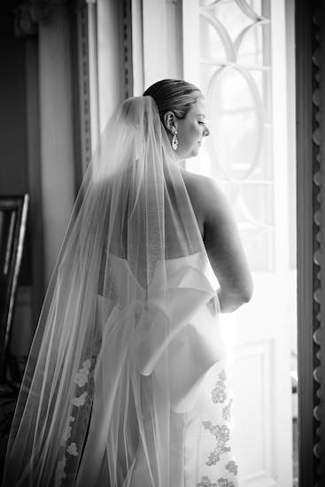 A bride looking out the window of The Governor Thomas Bennett House in Charleston