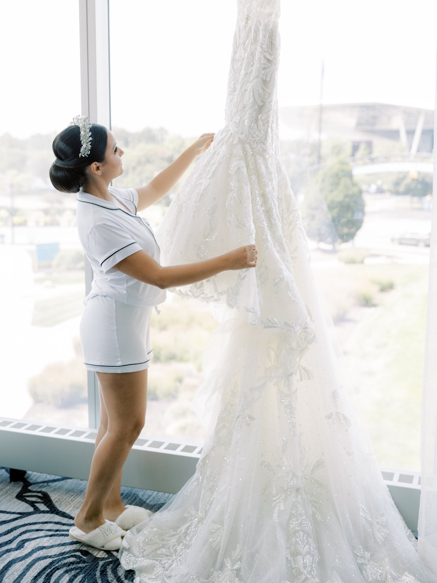 bride admiring her bridal gown