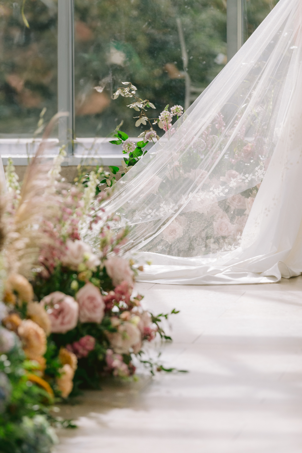 Wedding ceremony aisle decorated with pastel floral arrangements leading to the altar.