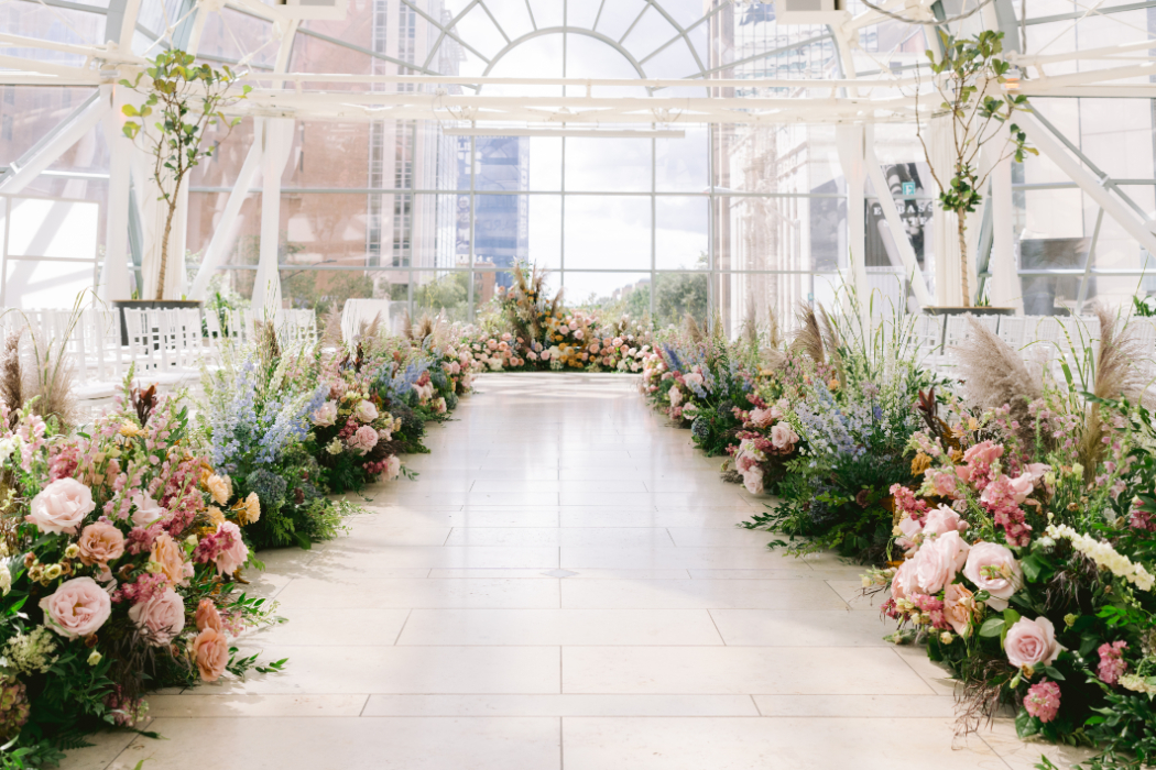 Wedding venue set up before the ceremony, with floral-decorated aisle.