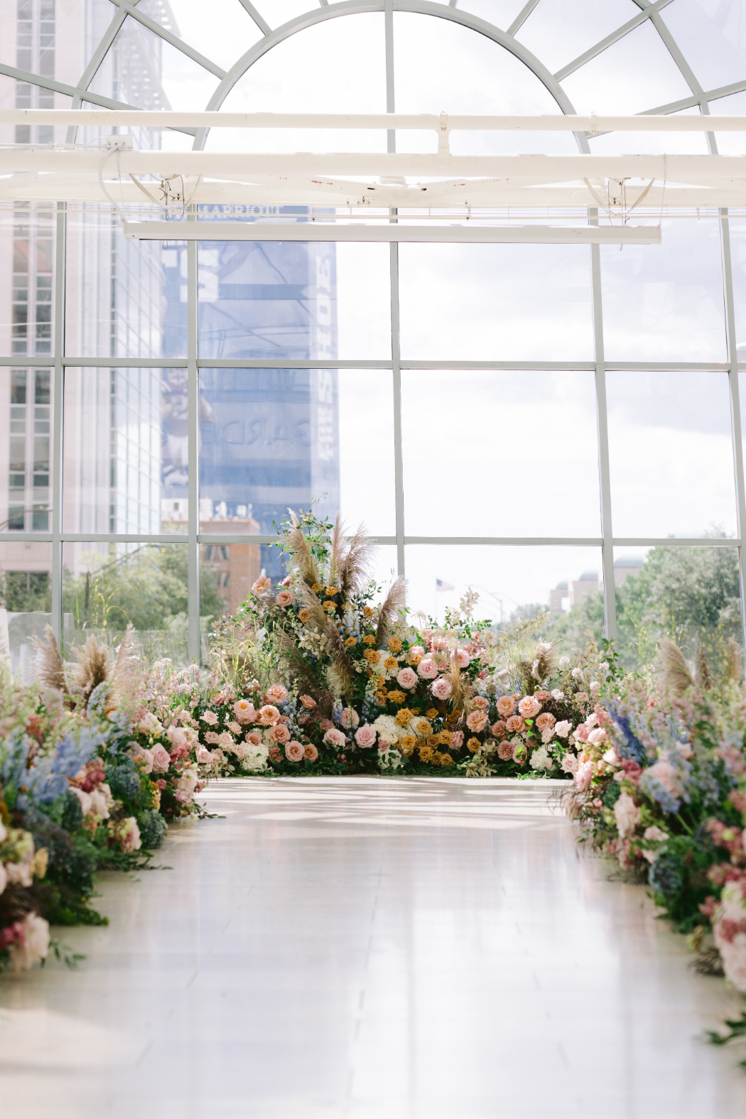 Wedding venue set up before the ceremony, with floral-decorated aisle.