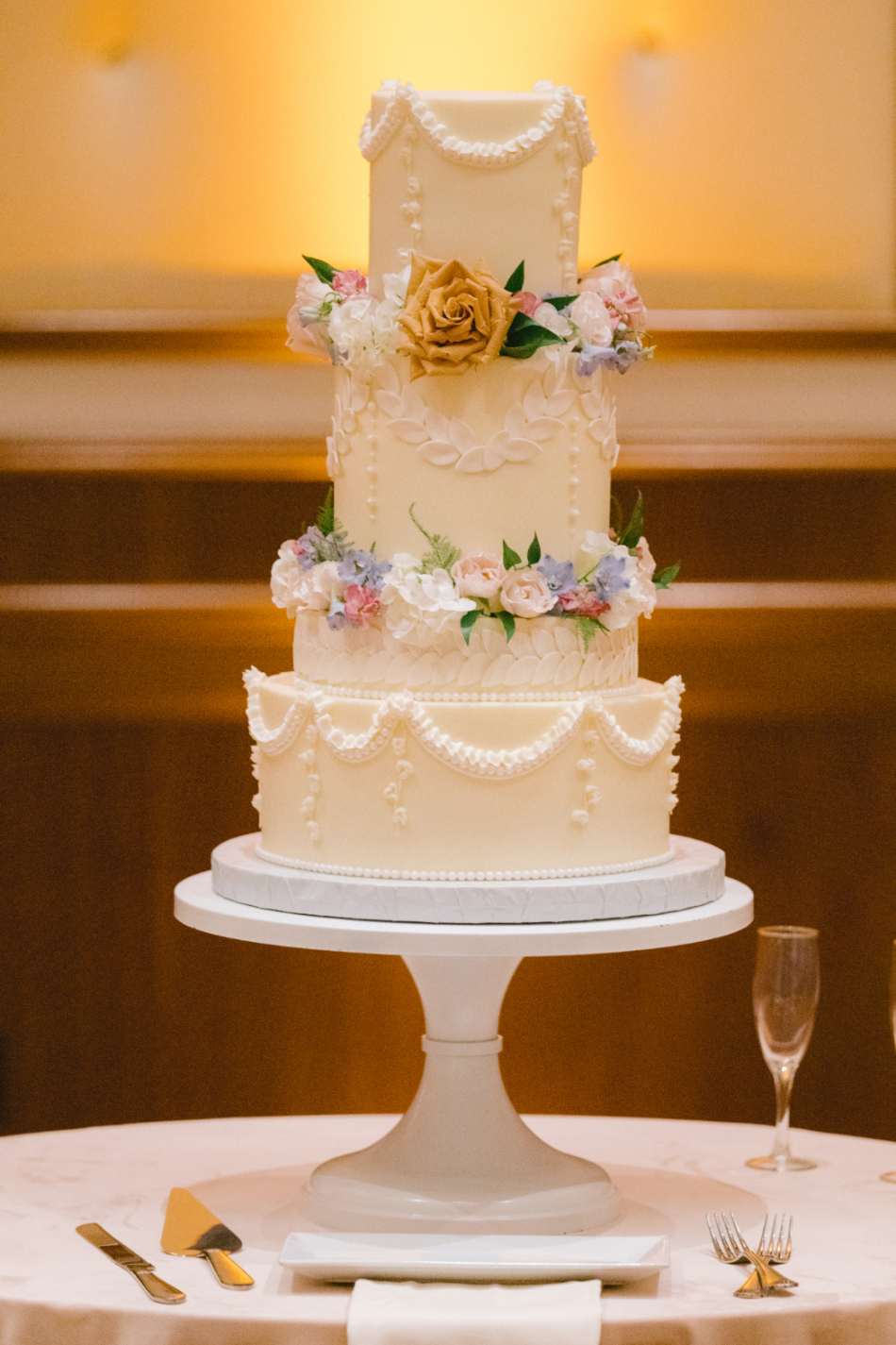 multi-tiered cake with intricate vintage piping, reminiscent of old-world Romanesque detailing