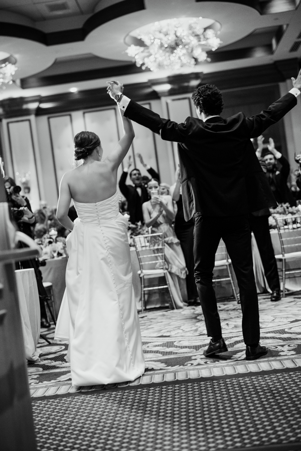 bride and groom enter wedding reception at arts garden