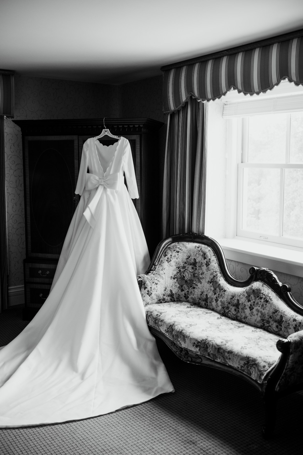 wedding dress with bow hanging up at West Baden Springs Resort wedding